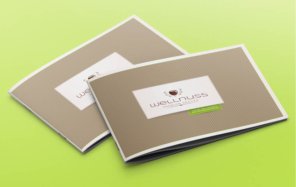 Farbige Geschenkboxen von Wellnuss Premium Snacks mit verschiedenen Editionen wie „Herzlichen Glückwunsch“, „Frohe Ostern“ und „Herrenabend“.